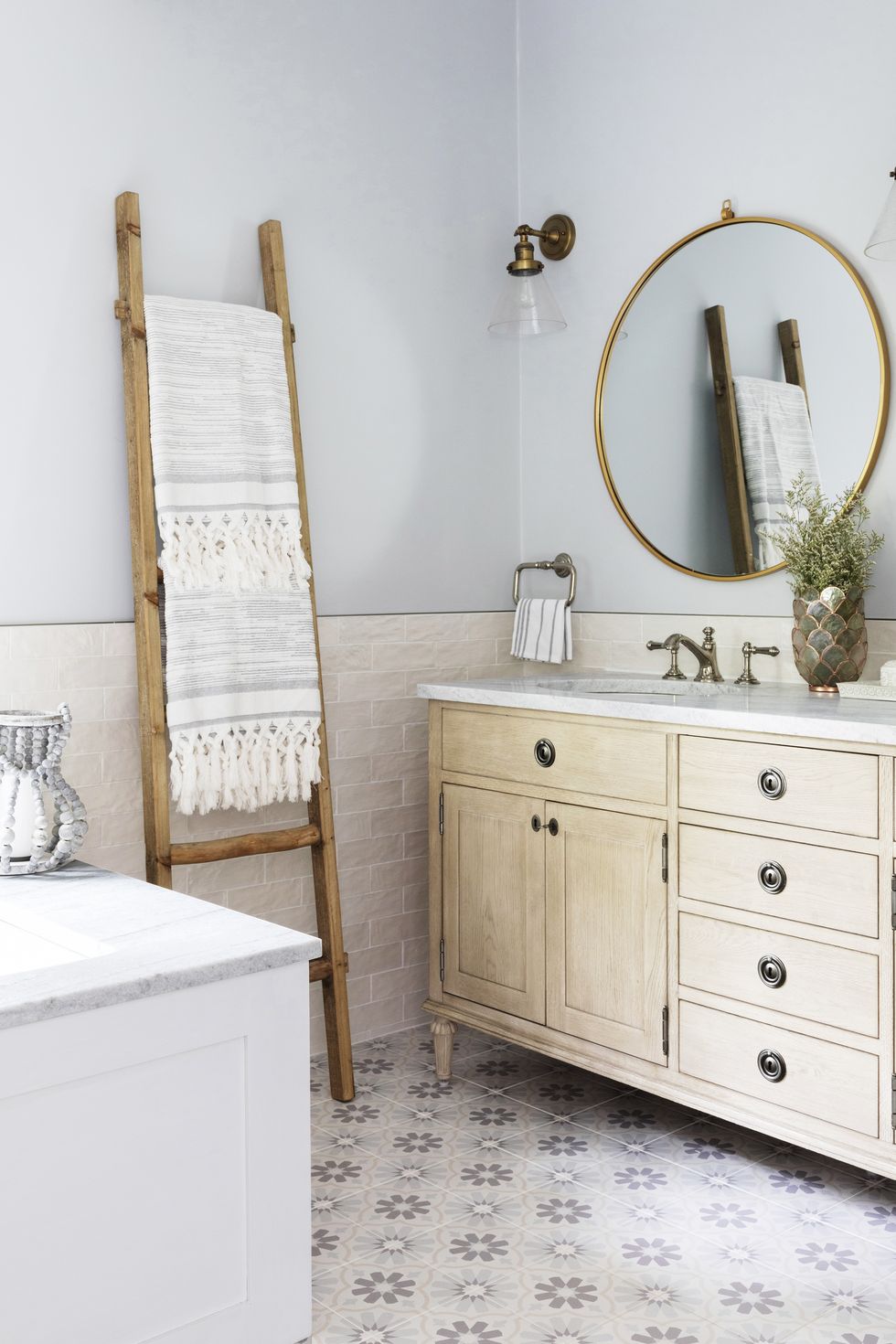 home featuring warm neutrals and soothing blue hues to accent the beautiful architecture of the vintage home interior designer karen b wolf bathroom with ladder as towel rod