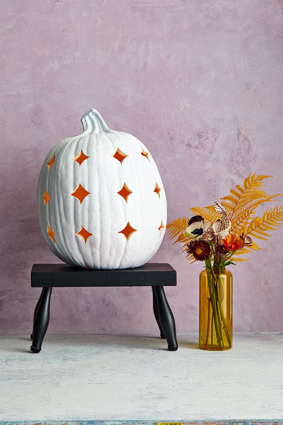 fall decor ideas, white pumpkin with carved stars on a small table