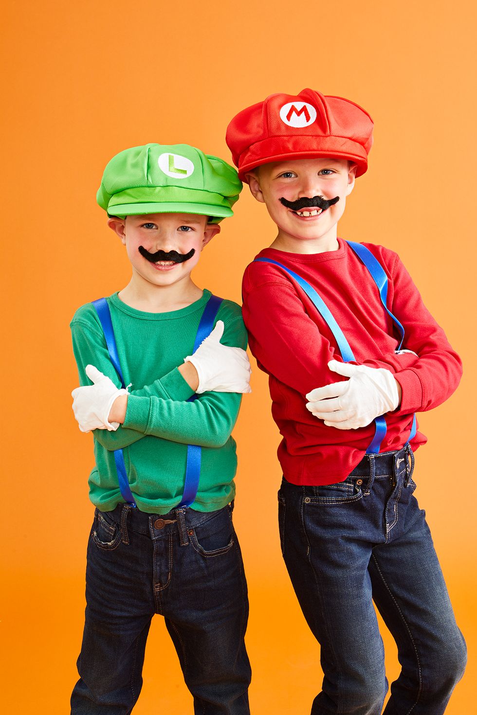 children dressed in long sleeve shirts and overalls to mimic mario and luigi