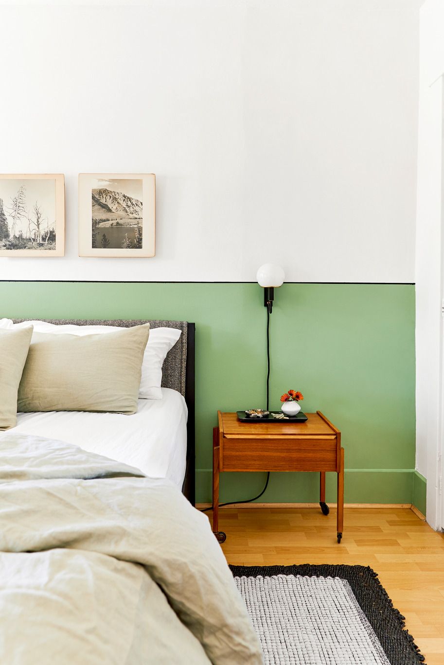Bedroom with a headboard painted green all along the wall