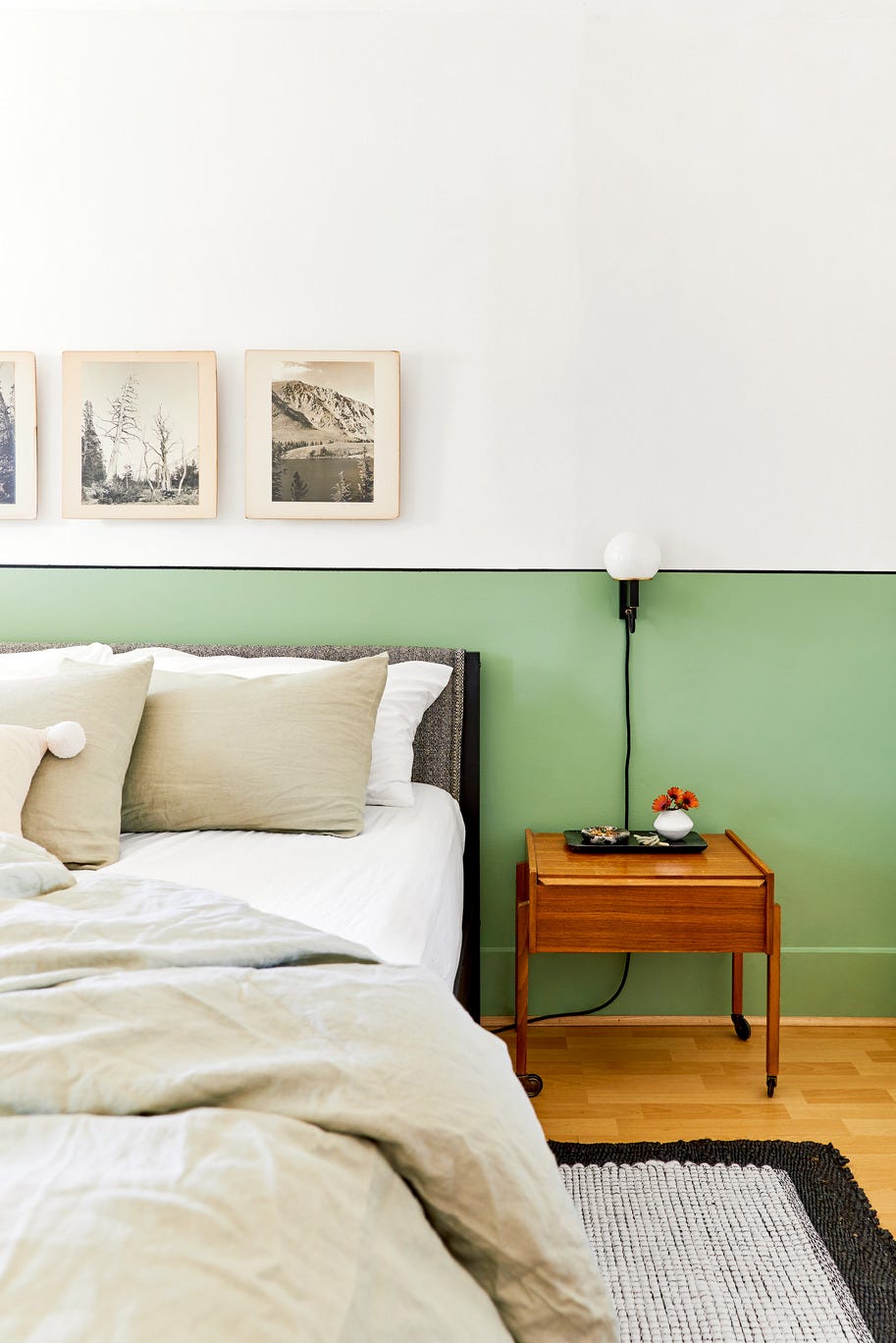 bedroom with wall to wall green painted headboard