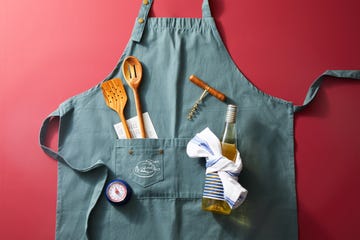 blue apron flatlay with thanksgiving cooking tools on red background