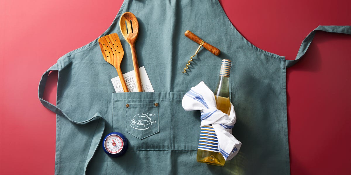 blue apron flatlay with thanksgiving cooking tools on red background blue apron flatlay with thanksgiving cooking tools on red background
