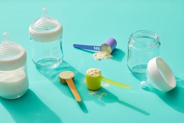 formula with baby bottles on a turquoise background