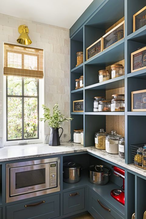 blue pantry with open shelves and microwave