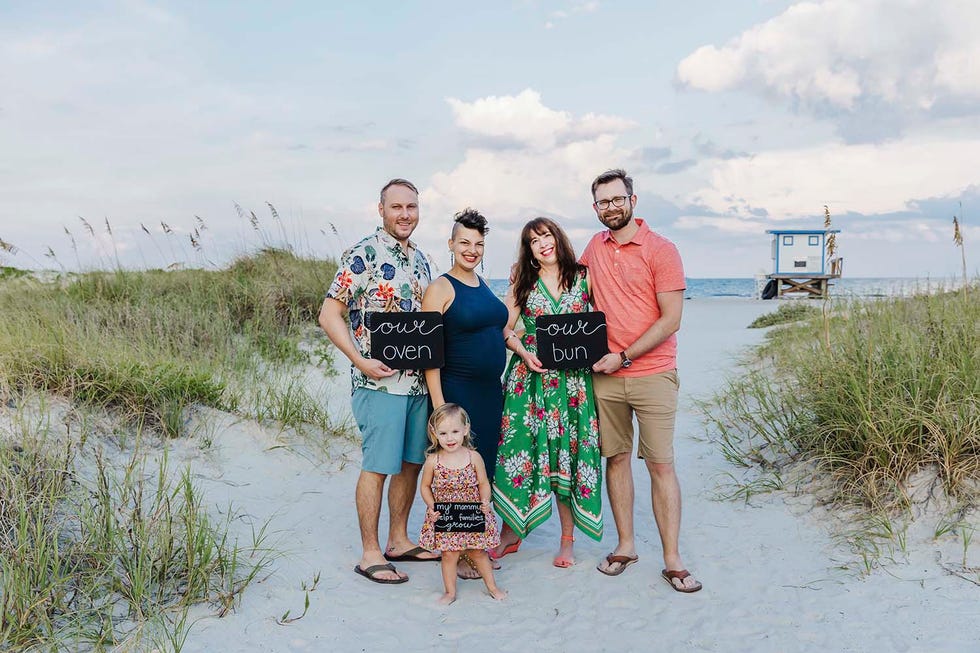 stephanie and mike lanzerotti and melly gonzalez de acevedo and cody epperson with their daughter farrah willow pose for a group photo on the beach