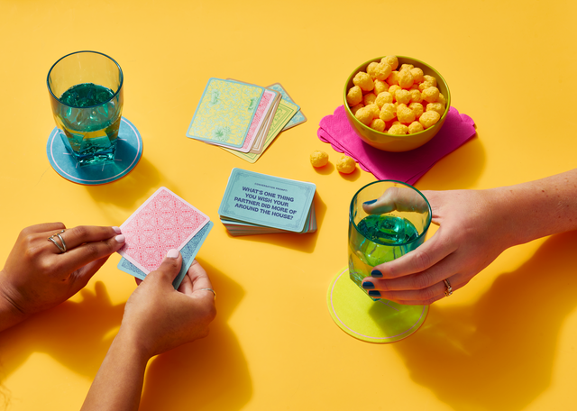 same sex couple playing a game of conversation cards