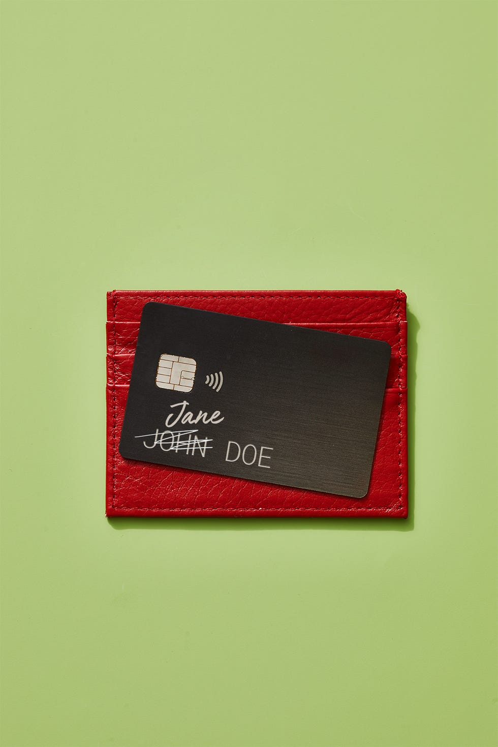 n top of red wallet with name scribbled out