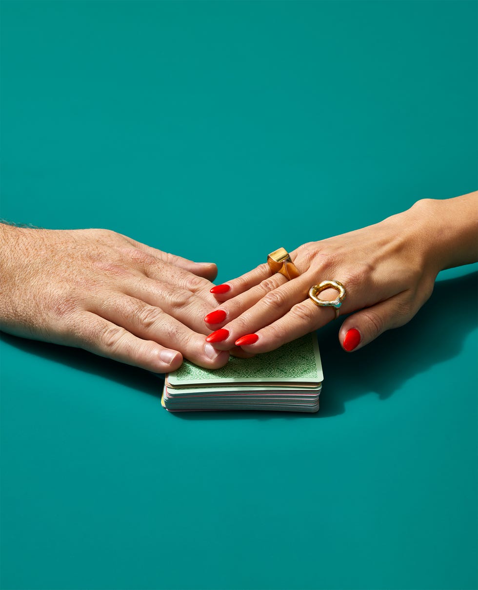a pair of hands with red nail polish