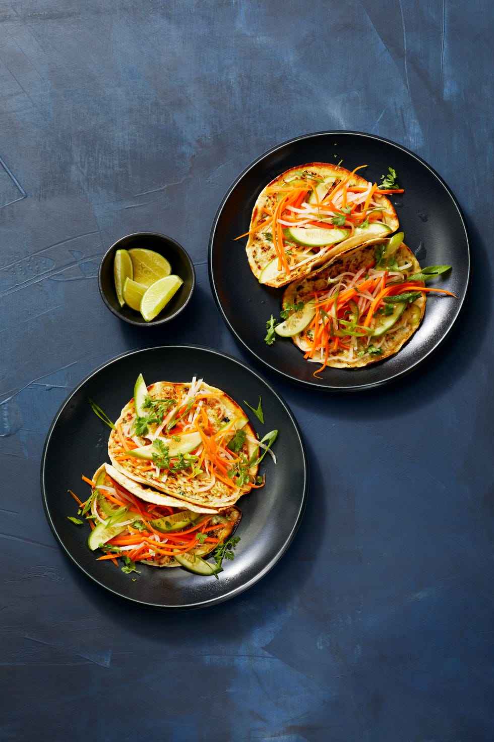chicken banh mi smash tacos on a black plate