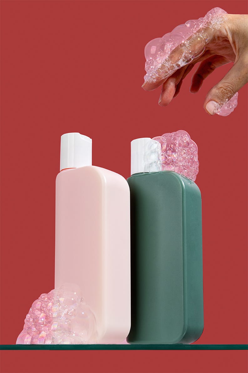 shampoo and conditioner on sudsy background