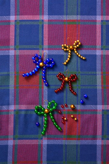 colorful beaded bows on a plaid fabric background