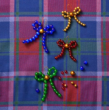 beaded bow ornaments colorful beaded bows on a plaid fabric background
