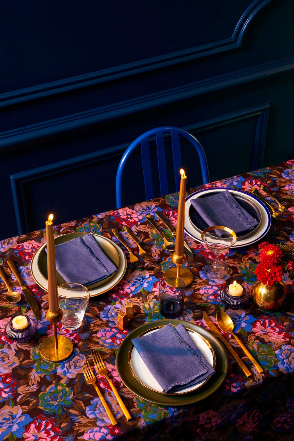table setting with gold dishes and floral tablecloth