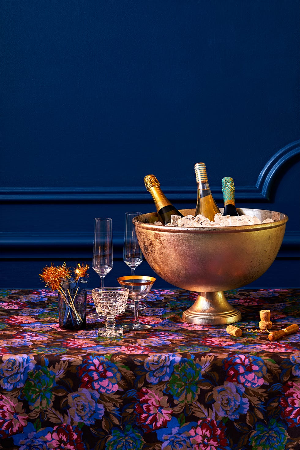 a festive table setting with champagne bottles glasses and decorative elements