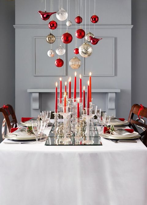 elegant table setting with tall candle holders with red taper candles