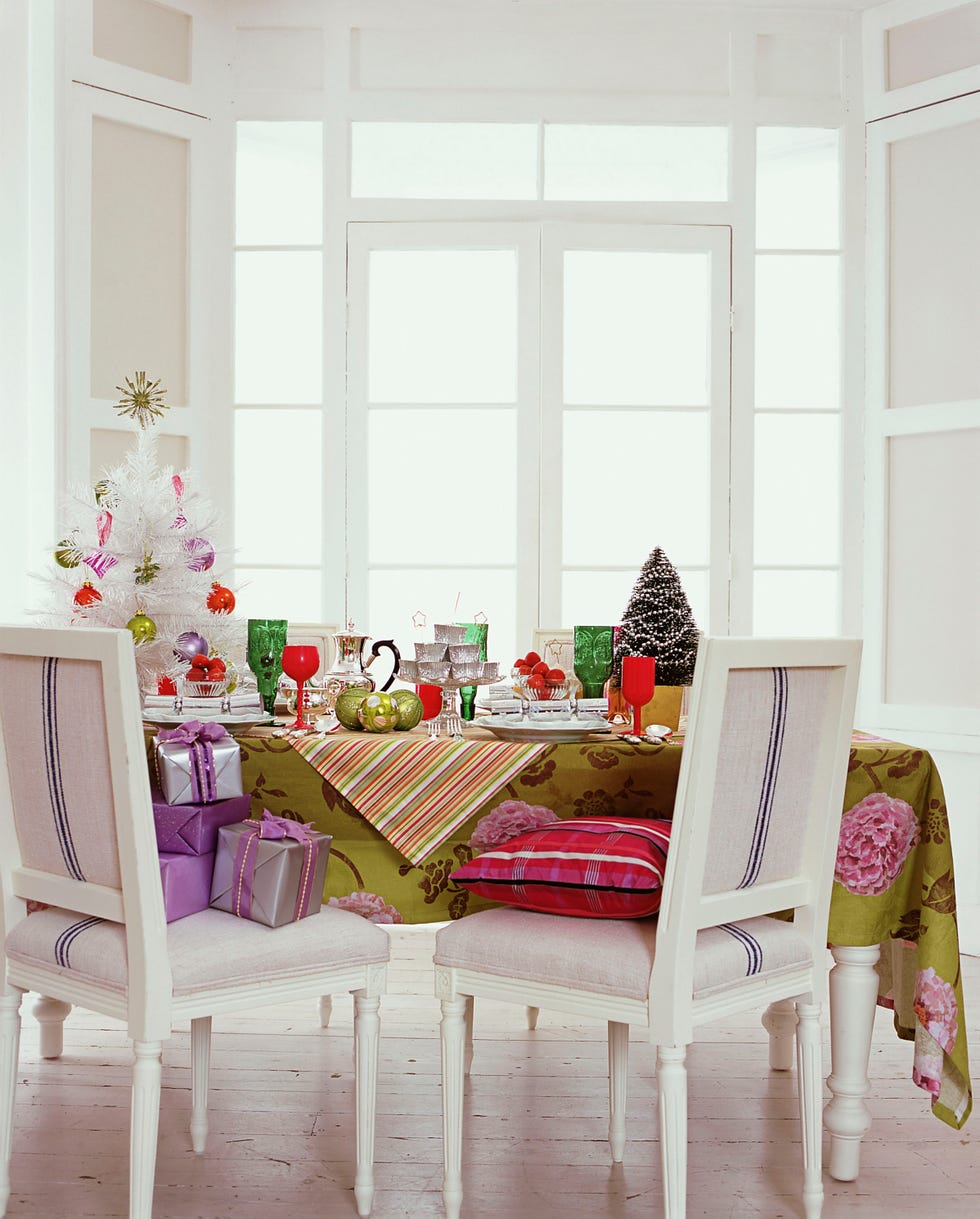 white christmas dining room with silver fake tree, presents and unique glassware