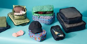 variety of packing cube sets on a blue set, good housekeeping's best packing cubes