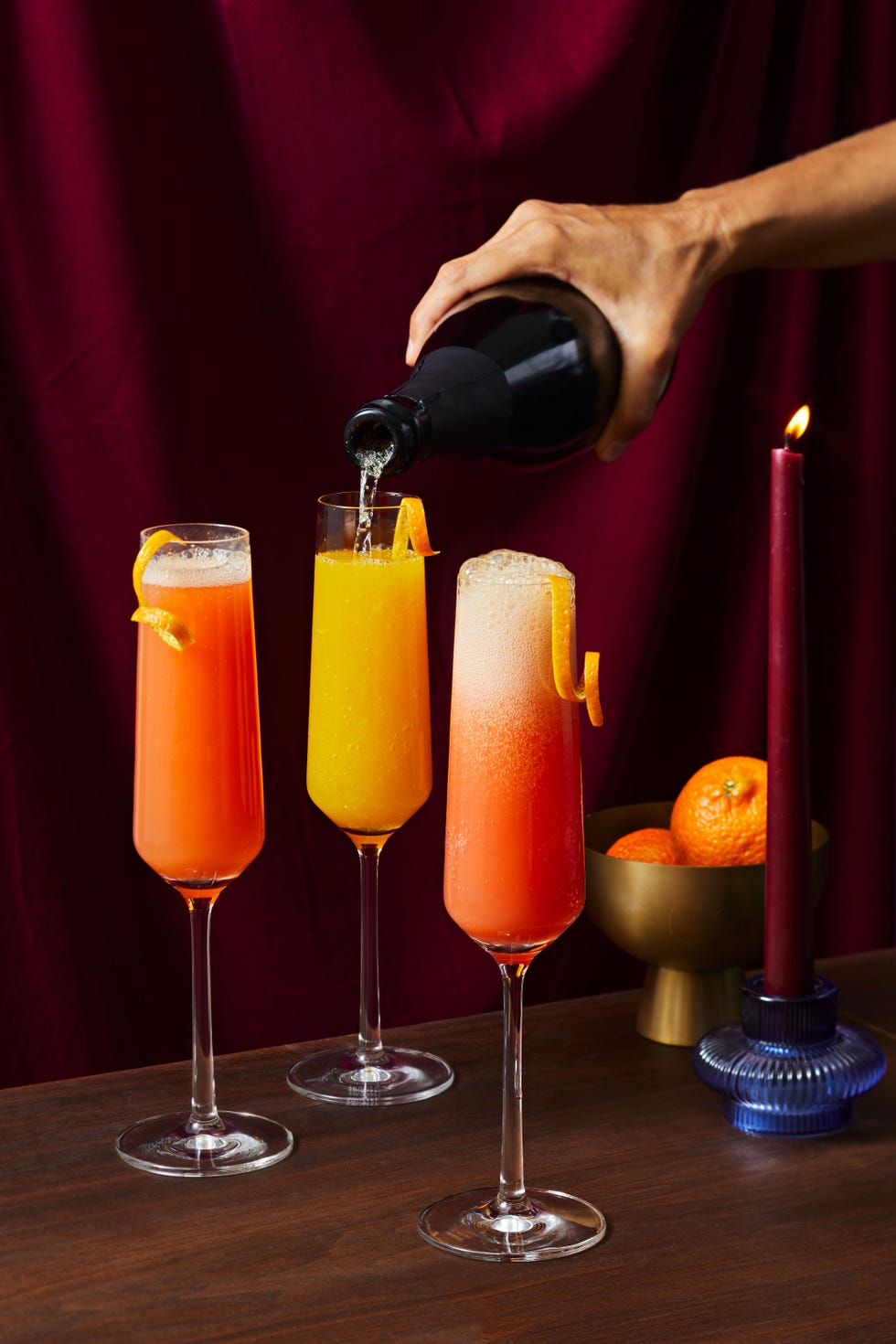 pink grapefruit, tangerine, and blood orange mimosas in champagne flutes