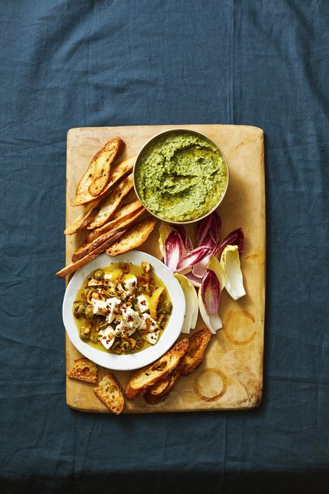 herbed white bean dip on wood cutting board with bread