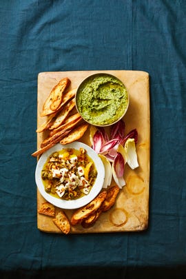 herbed white bean dip on wood cutting board with bread