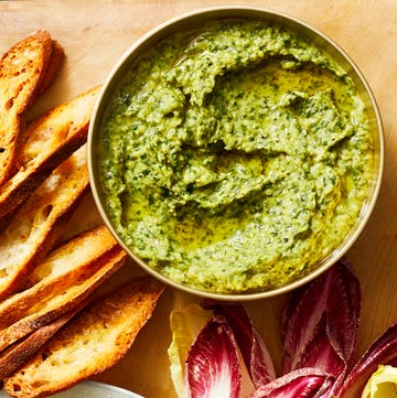 herbed white bean dip on wood cutting board with bread