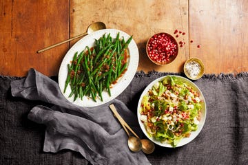 escarole salad with red wine vinaigrette, sherry glazed green beans, and a small bowl of pomegranate seeds