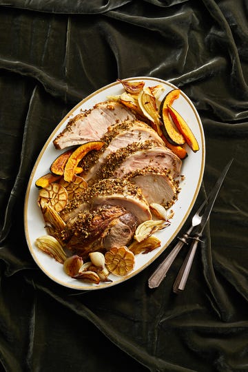 fennel crusted roast pork with acorn squash on a white plate