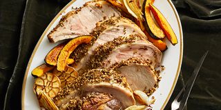 fennel crusted roast pork with acorn squash on a white plate