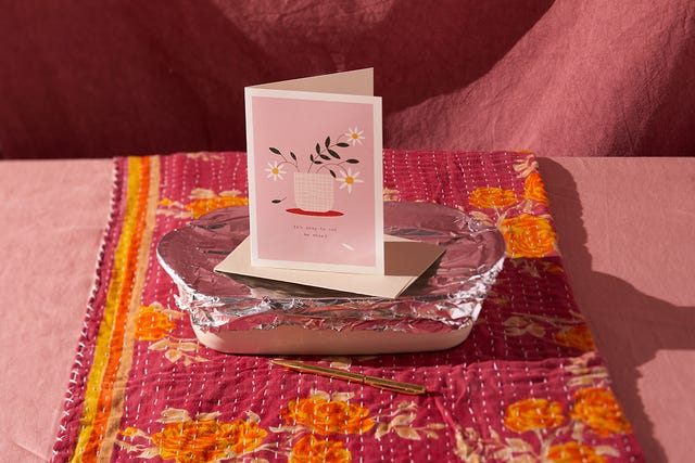 sympathy card on top of casserole dish with foil