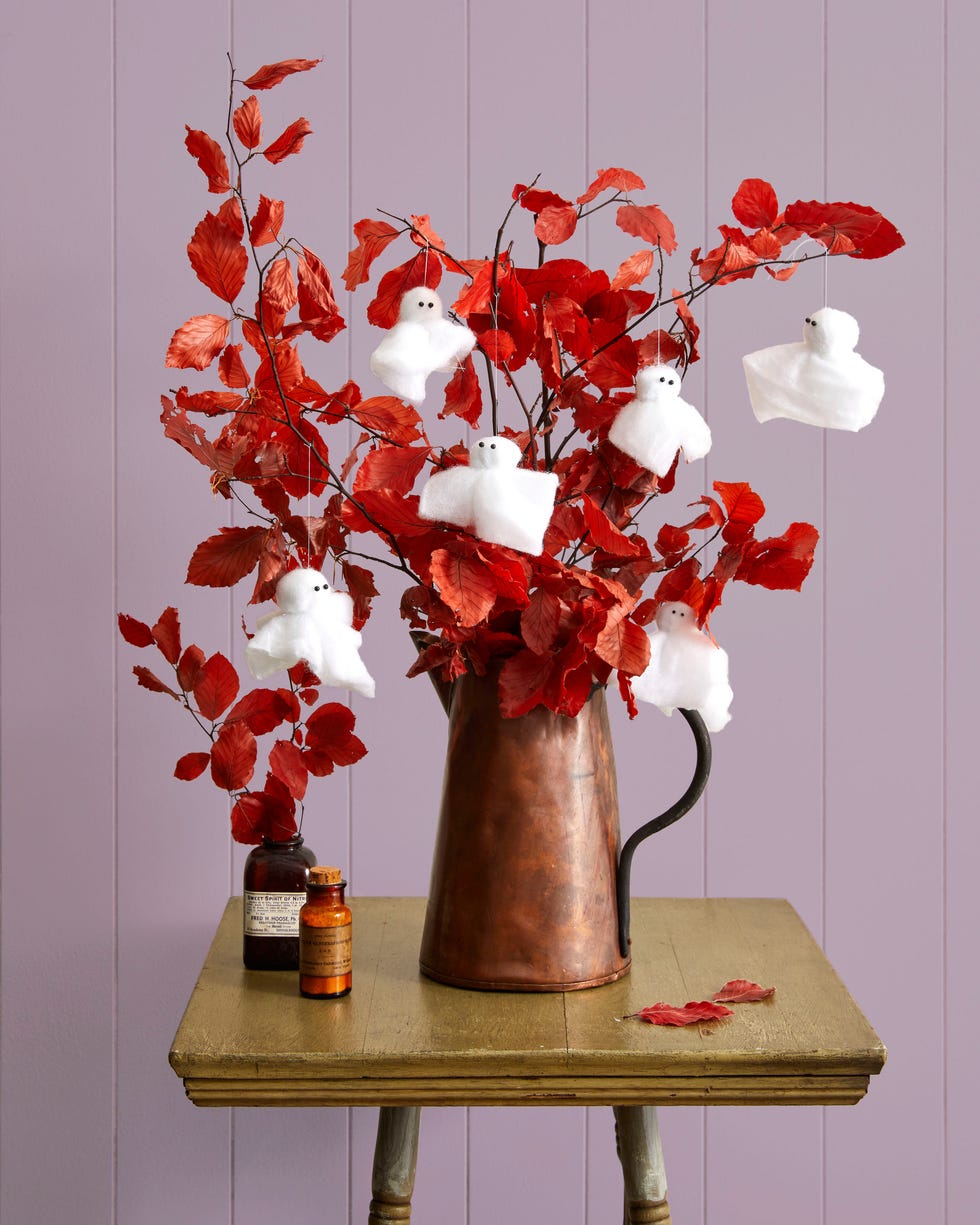 fall branches with DIY ghosts made from pollyfill hanging from them fall branches with diy ghosts made from pollyfill hanging from them