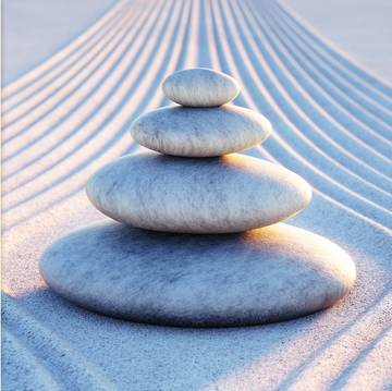 stack of rocks on sand with blueish hue