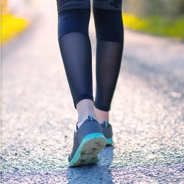 low angle view of woman walking on pavement