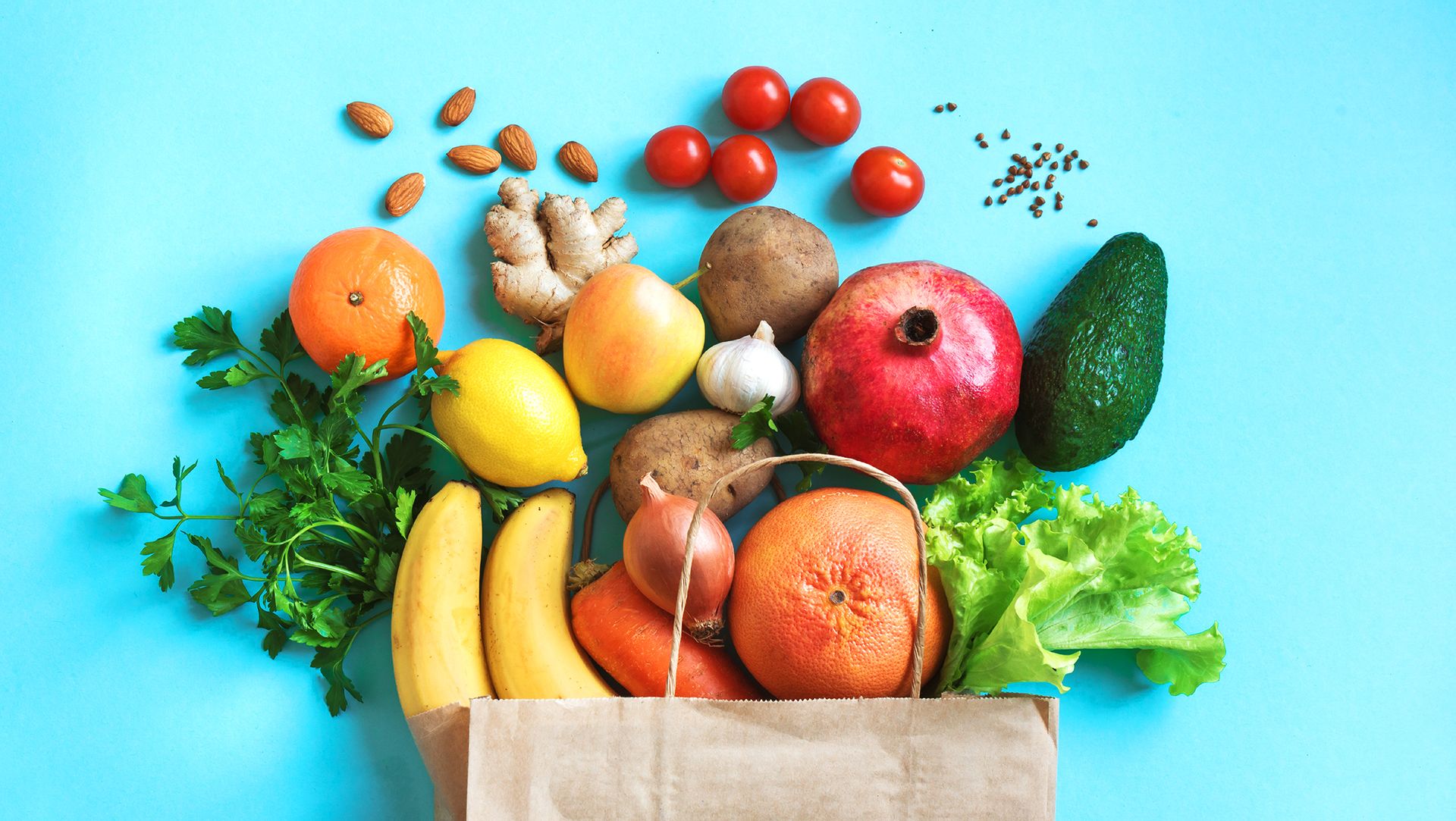 healthy food background healthy vegan vegetarian food in paper bag vegetables and fruits on blue, copy space, banner shopping food supermarket and clean vegan eating concept