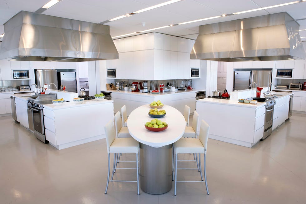 good housekeeping test kitchen with tasting table and four separate cooking stations
