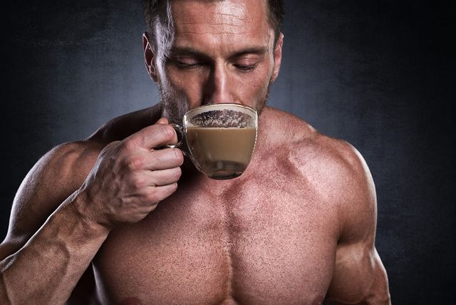studio shot of male fitness athlete while drinking coffee