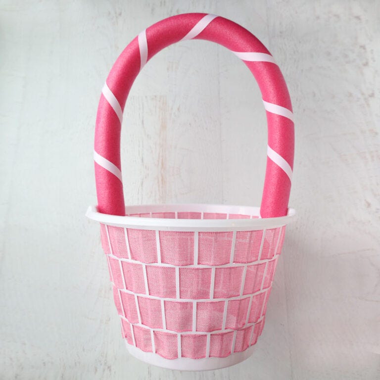 pink woven basket with a curved handle