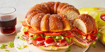 bundt cake bread filled with sliced salami, ham, provolone, tomatoes, lettuce, and pepperoni