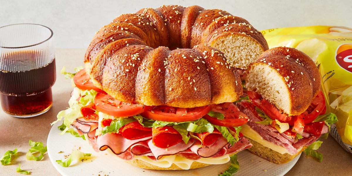 bundt cake bread filled with sliced salami, ham, provolone, tomatoes, lettuce, and pepperoni