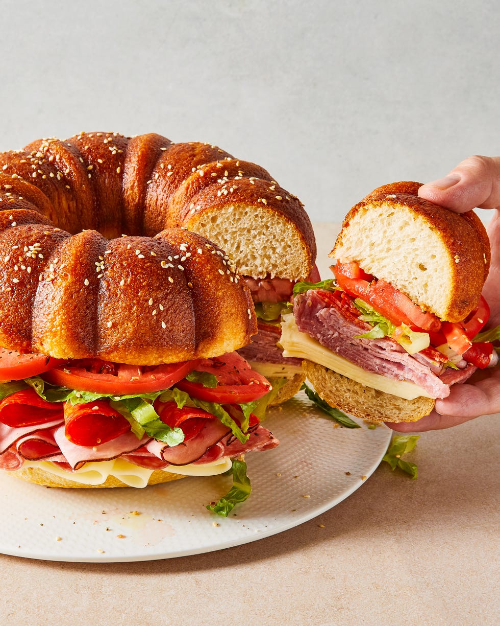 bundt cake bread filled with sliced salami, ham, provolone, tomatoes, lettuce, and pepperoni
