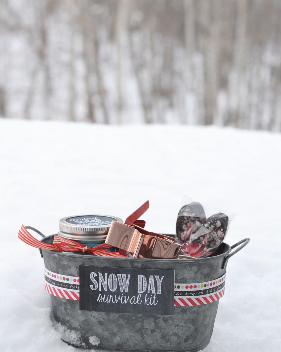 snow day survival kit in a metal basket sitting in the snow