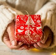 woman holding red wrapped gift
