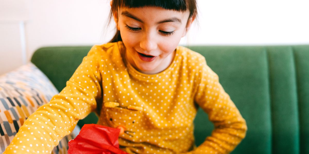 7 year old girl opening up gift