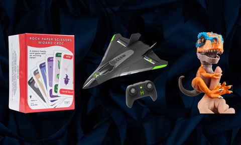 a card game, drone plane and dino toy in a row