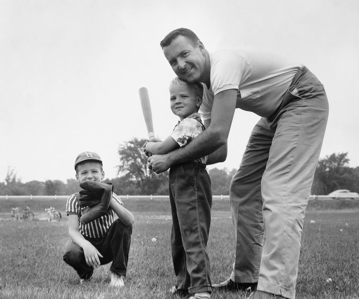 father and sons playing baseball