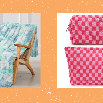 blue tie dye fuzzy blanket and pink checkered cosmetic bags on an orange background