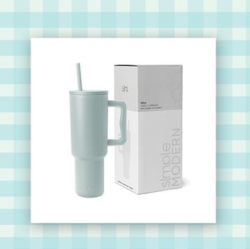 pale blue simple modern water tumbler with lid and handle and a white vegan leather handbag on a checkered background