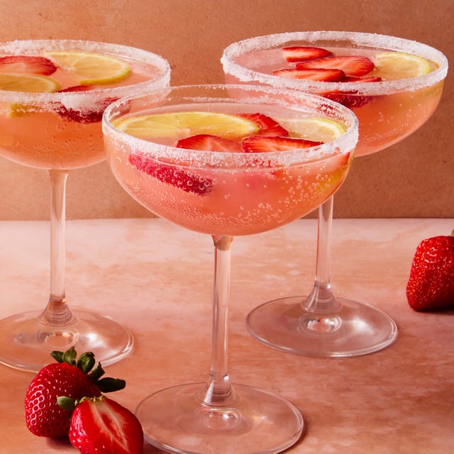 Giggle Juice pink cocktail with sliced strawberries and lemon