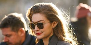 paris, france   february 26 gigi hadid wears sunglasses, a gray jacket, a green wool pullover, outside lanvin, during paris fashion week   womenswear fallwinter 20202021, on february 26, 2020 in paris, france photo by edward berthelotgetty images