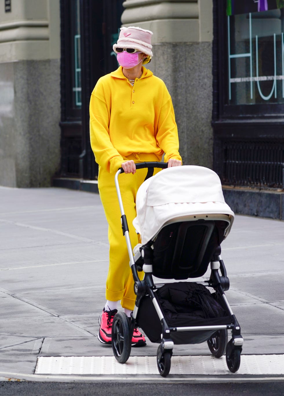 Gigi Hadid Wears a Yellow Sweat Suit and Prada Bucket Hat in NYC